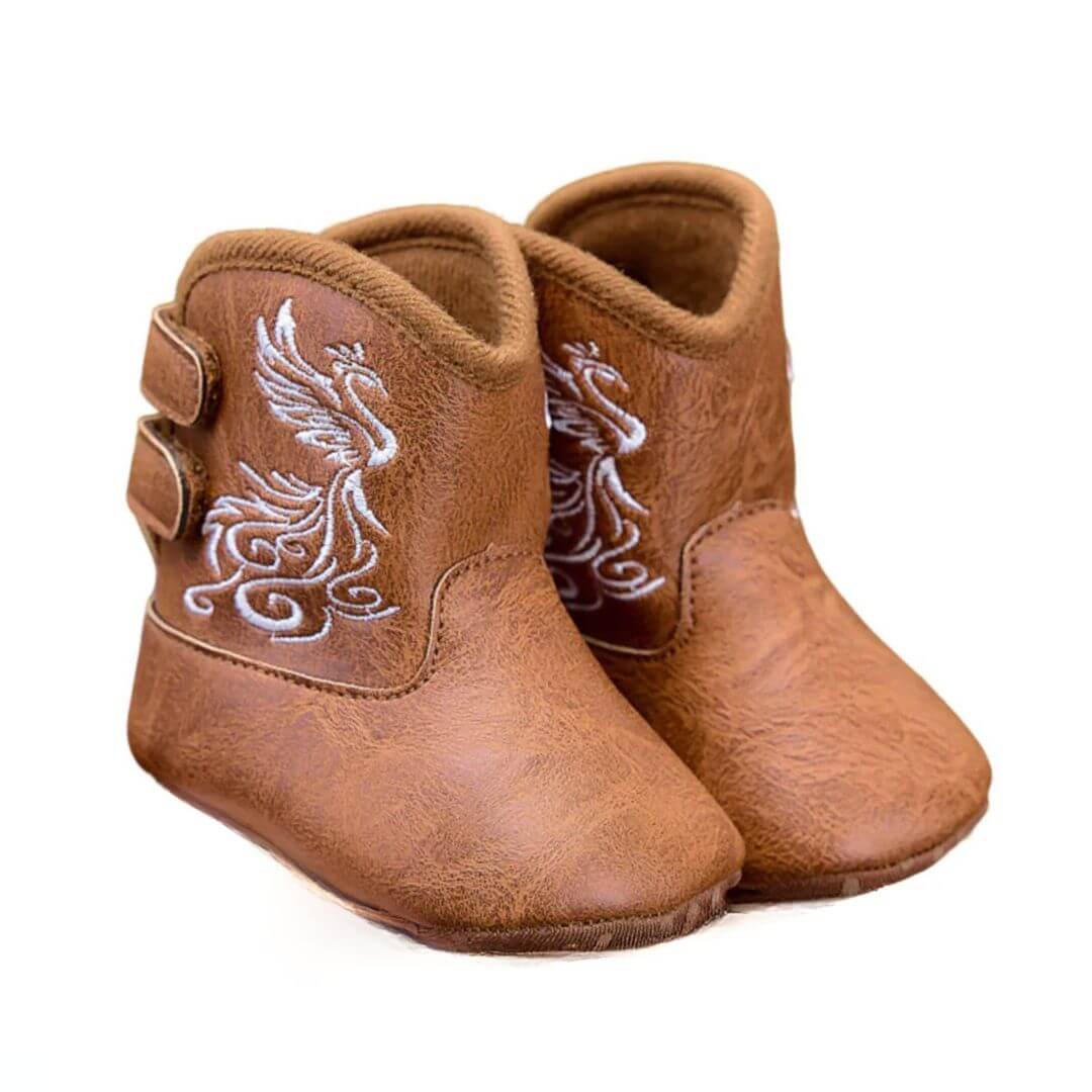 Tan faux leather baby cowboy boots with decorative Western stitching and pull-on tabs