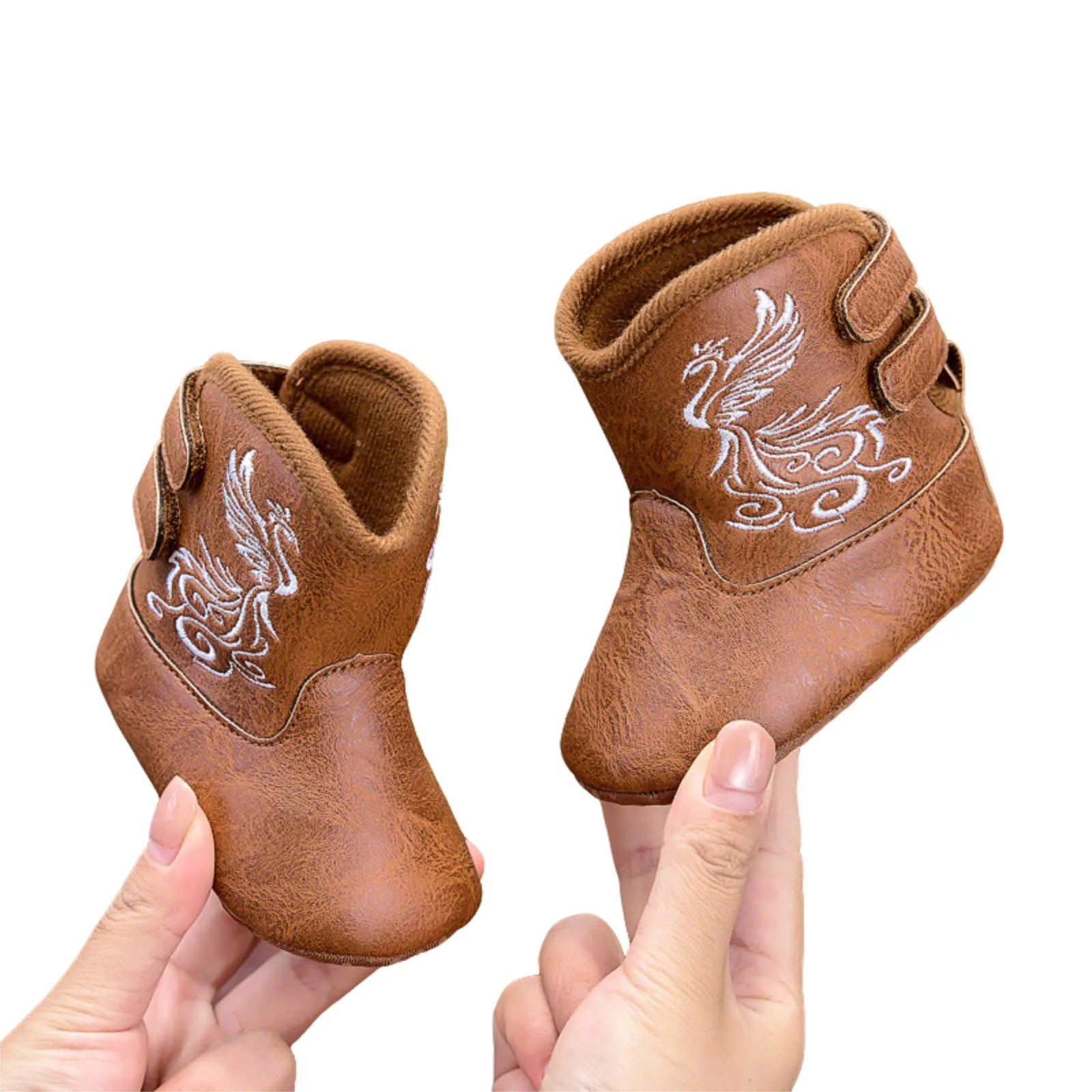 Tan faux leather baby cowboy boots with decorative Western stitching and pull-on tabs