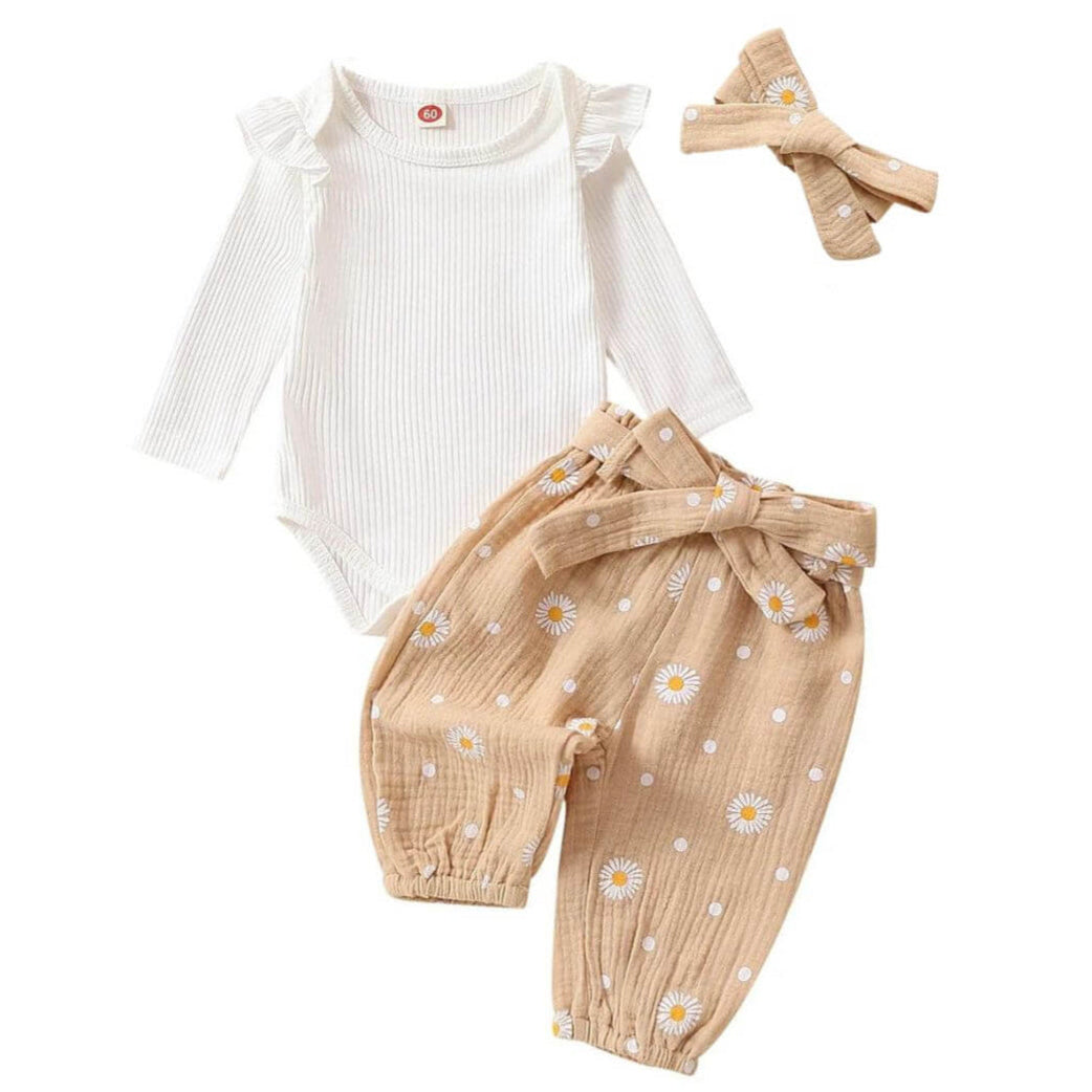 Baby girl outfit with white ribbed ruffle onesie, beige floral muslin pants and matching headband.