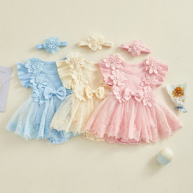 Three baby dresses in blue, yellow, and pink with floral details