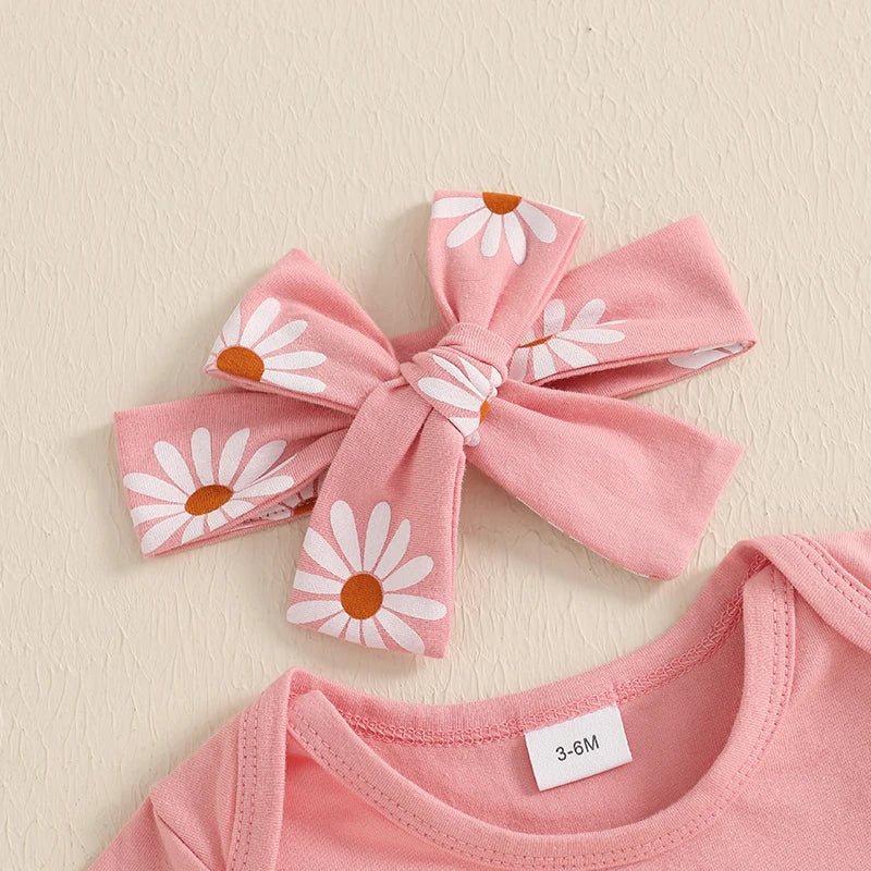 Closeup of headband on baby girl pink first birthday outfit.