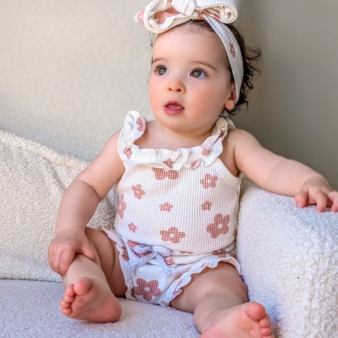Adorable baby girl wearing floral baby outfit from Lulu Babe