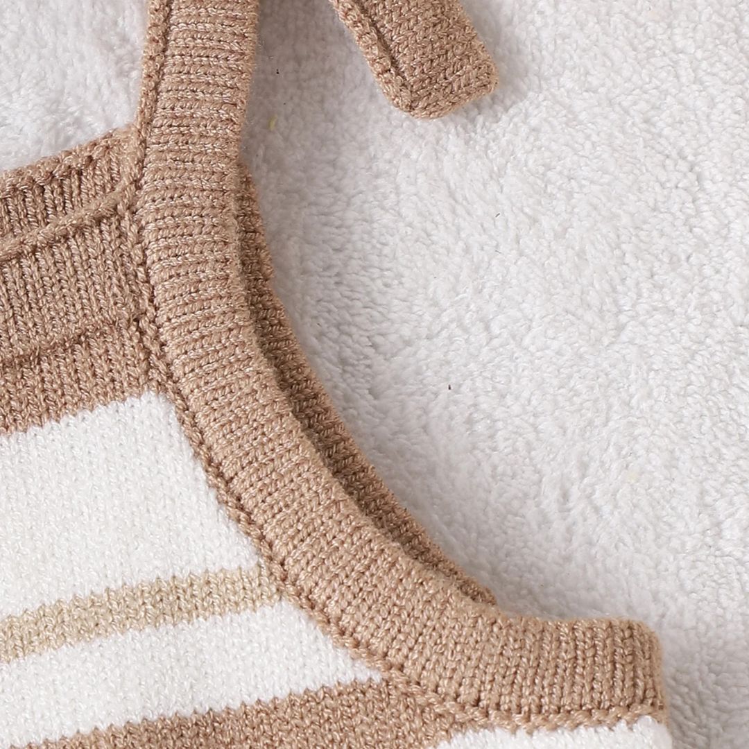 Cleo Knit Romper adjustable tie-shoulder straps in soft neutral tones for baby girls.