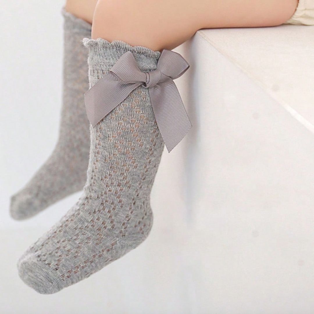 Lifestyle image of baby girl grey lace socks with bow