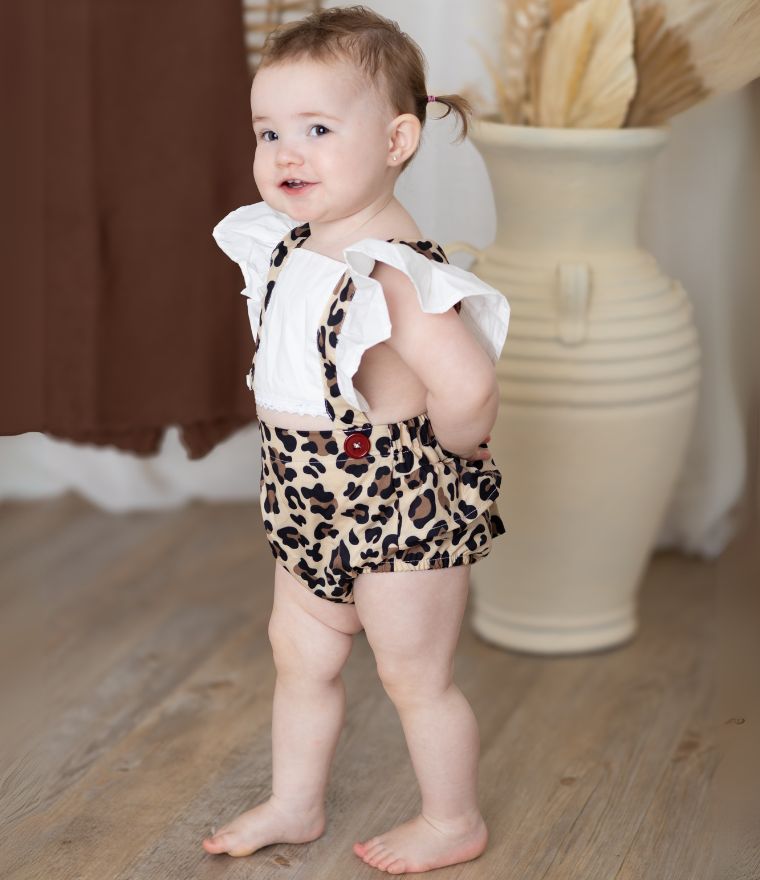 Baby girl wearing leopard pinafore romper