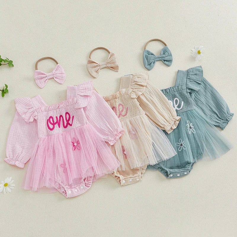 Baby girl pink first birthday tutu rompers with embroidered "one" script in pink, cream and green