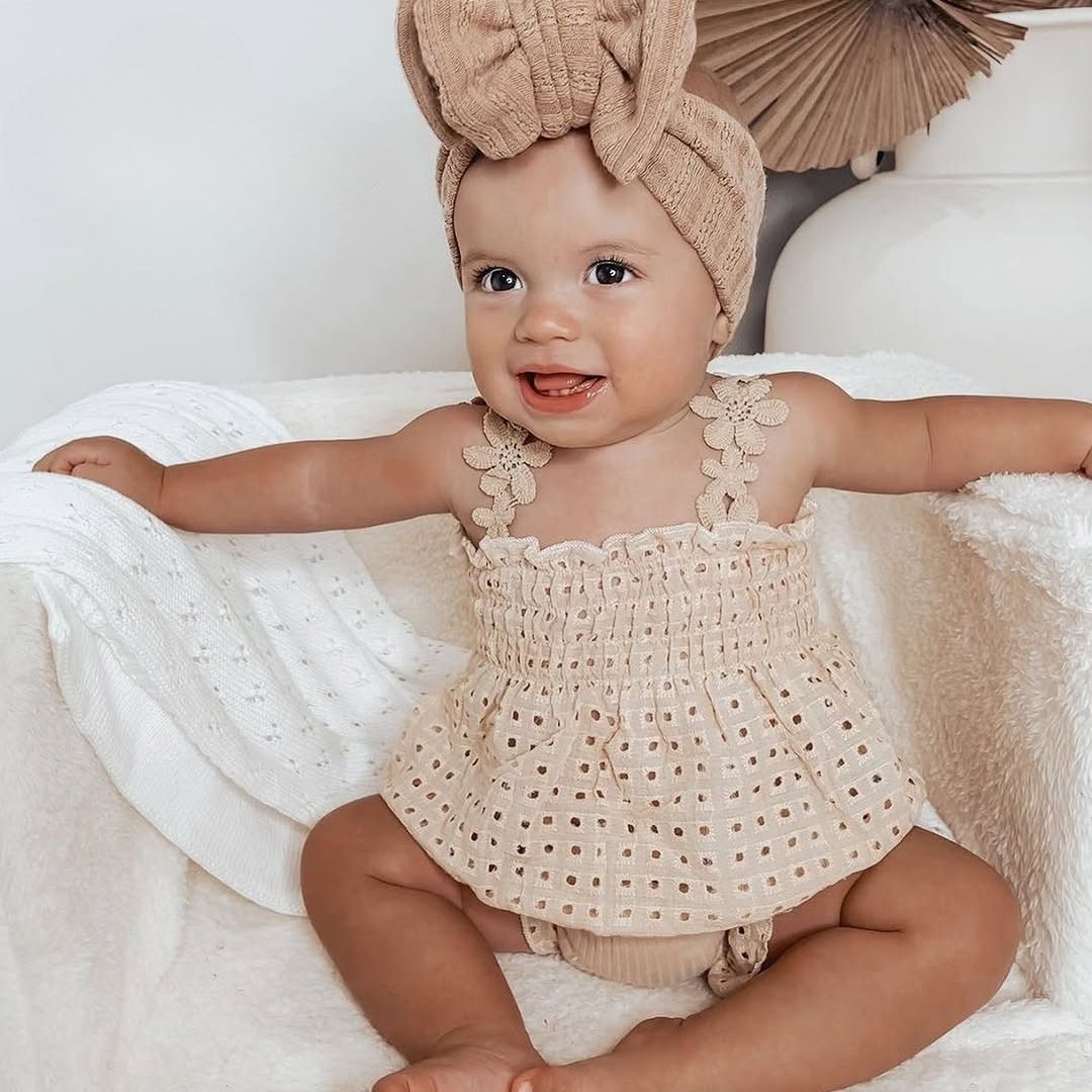 Baby girl wearing Celeste boho lace outfit in beige