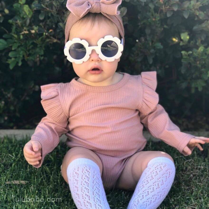 baby girl outfit featuring ribbed flutter romper, knee socks, flower sunnies and headband