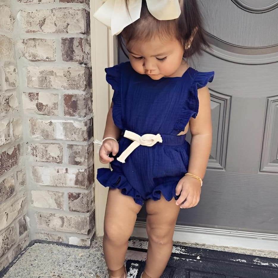 Baby girl wearing blue Willow Ruffle Romper
