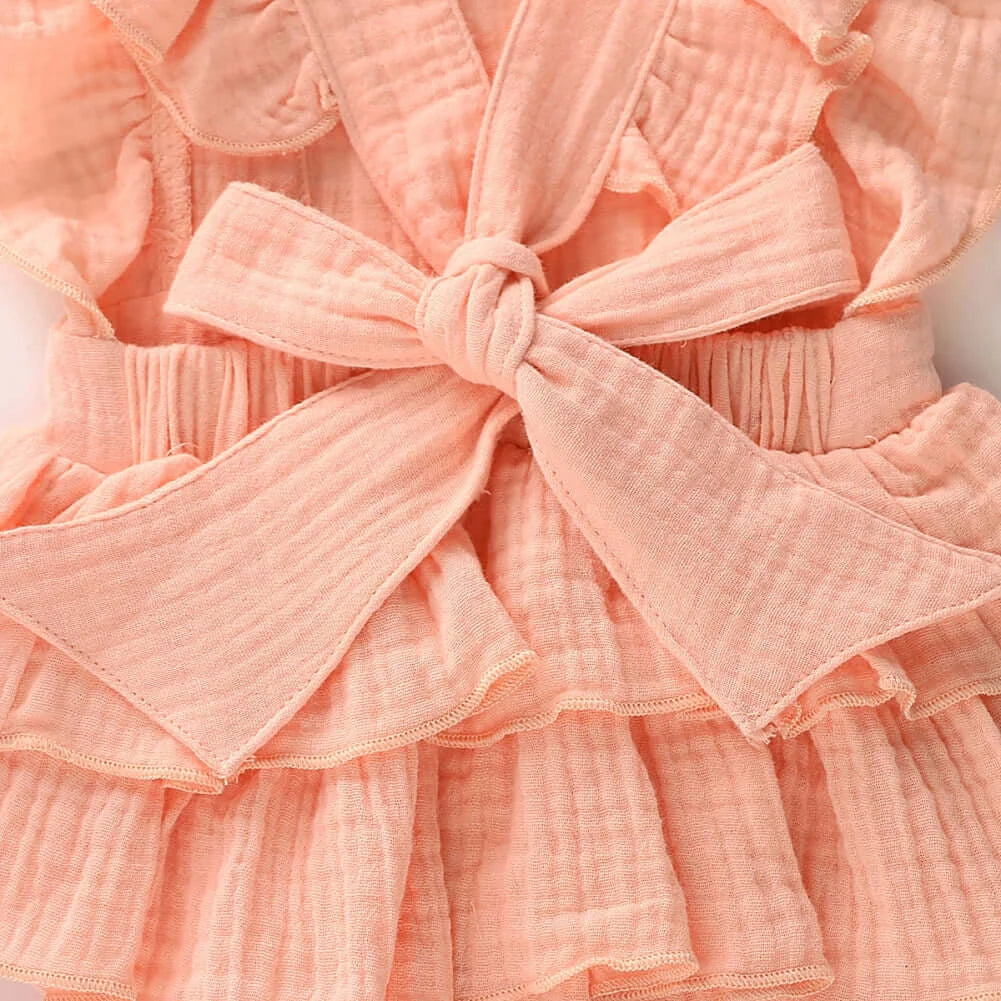 Closeup of Jennifer Ruffle Baby Girl Romper in pink showing back bow