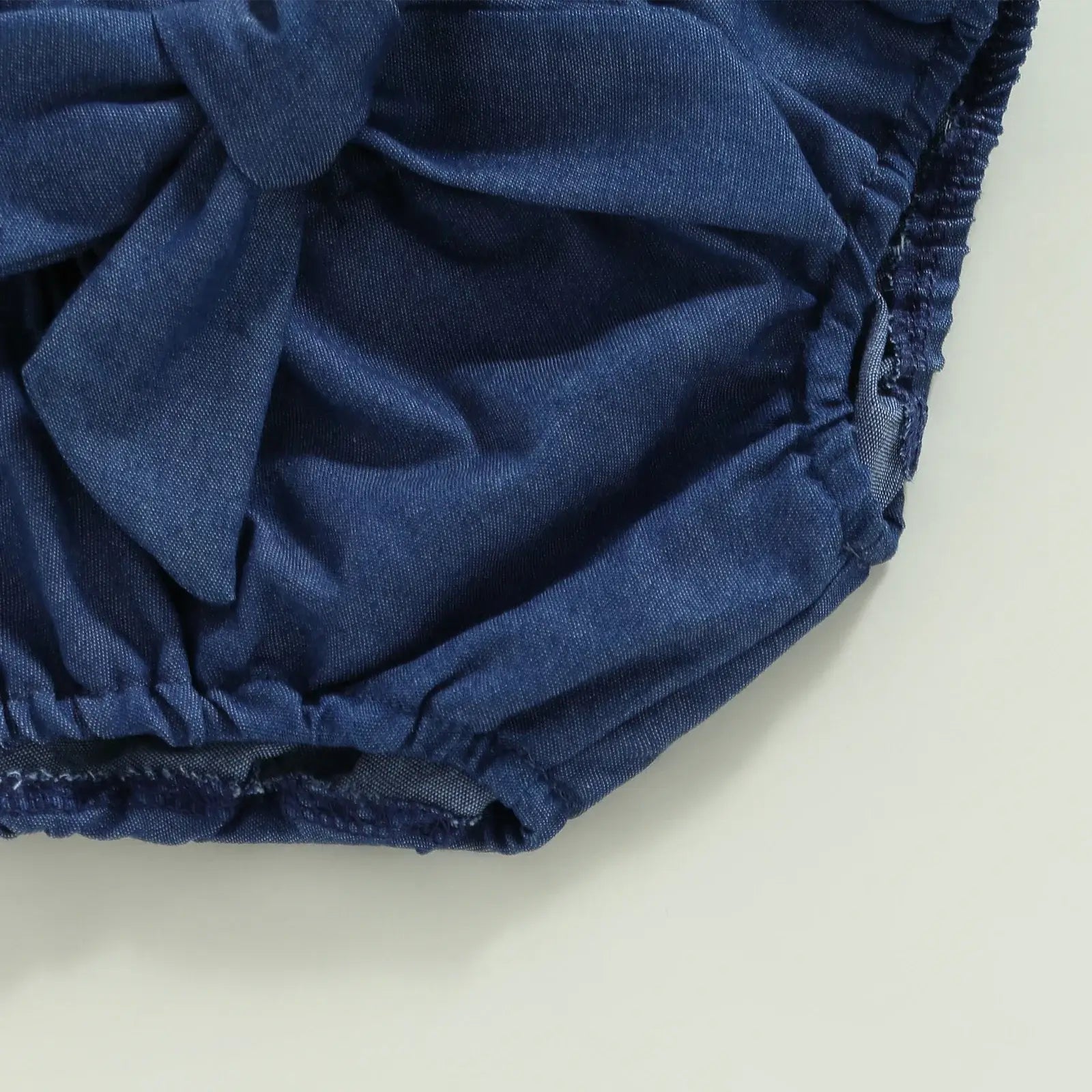 Closeup of Scarlett baby girl halter denim set