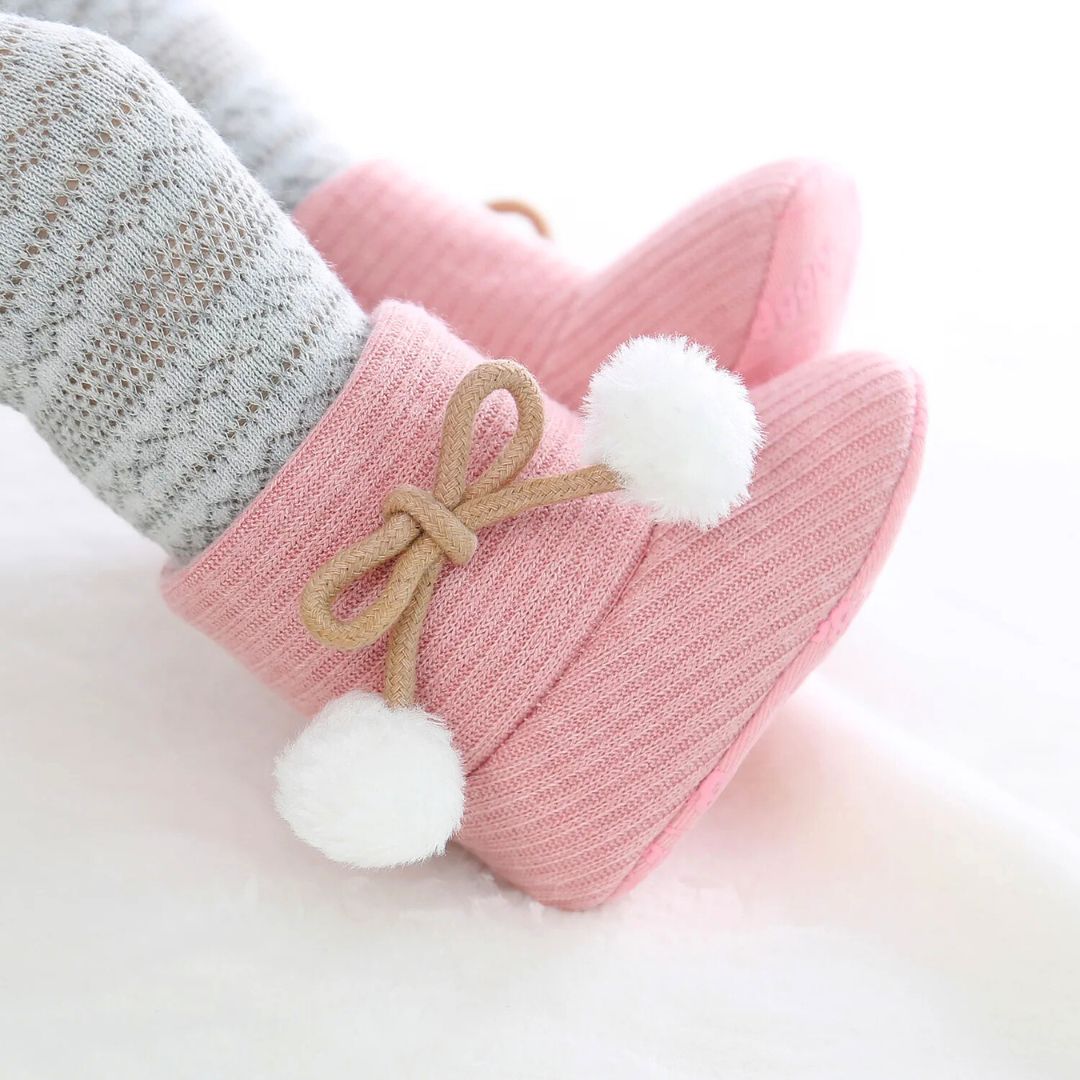 Pink baby ugg boots with pom pom bow