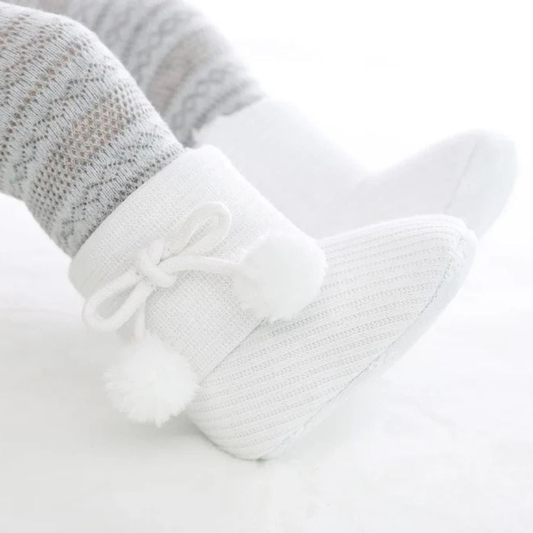 White baby ugg boots with pom pom bow