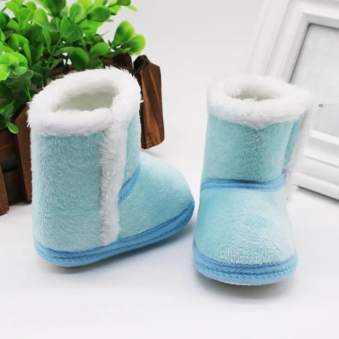 Blue baby slipper boots with fluffy lining, perfect for winter baby booties and keeping tiny toes warm.