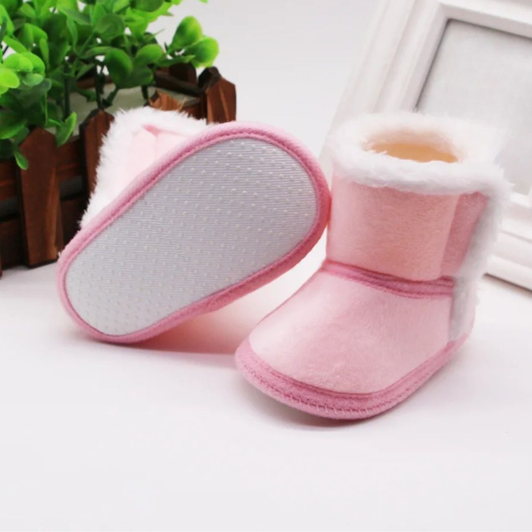 Soft pink baby slipper boots with fluffy lining, ideal winter baby booties for tiny toes.