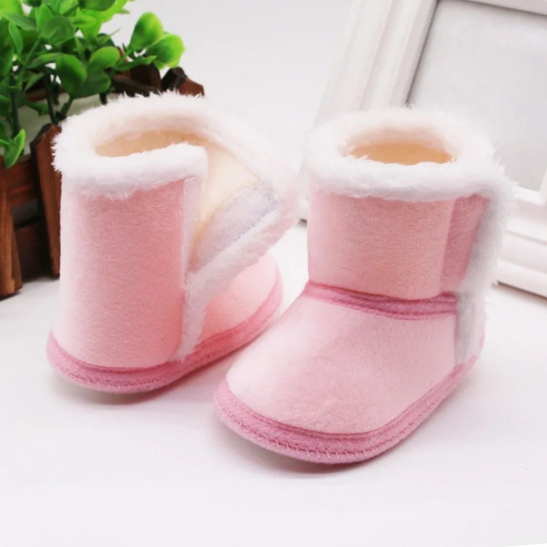 Cozy pink baby slipper boots with fluffy lining, ideal for warm winter comfort for babies 0-18 months.