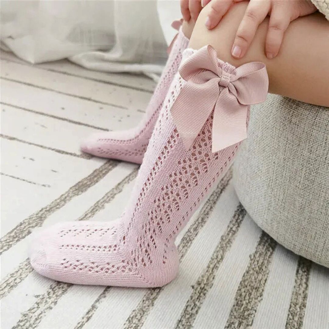 Lifestyle image of pink knee high baby socks