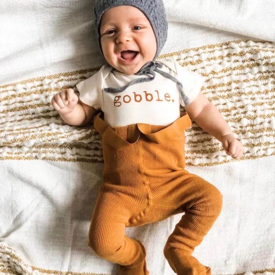 Cute baby wearing pink ribbed suspender tights in mustard - Lulu Babe