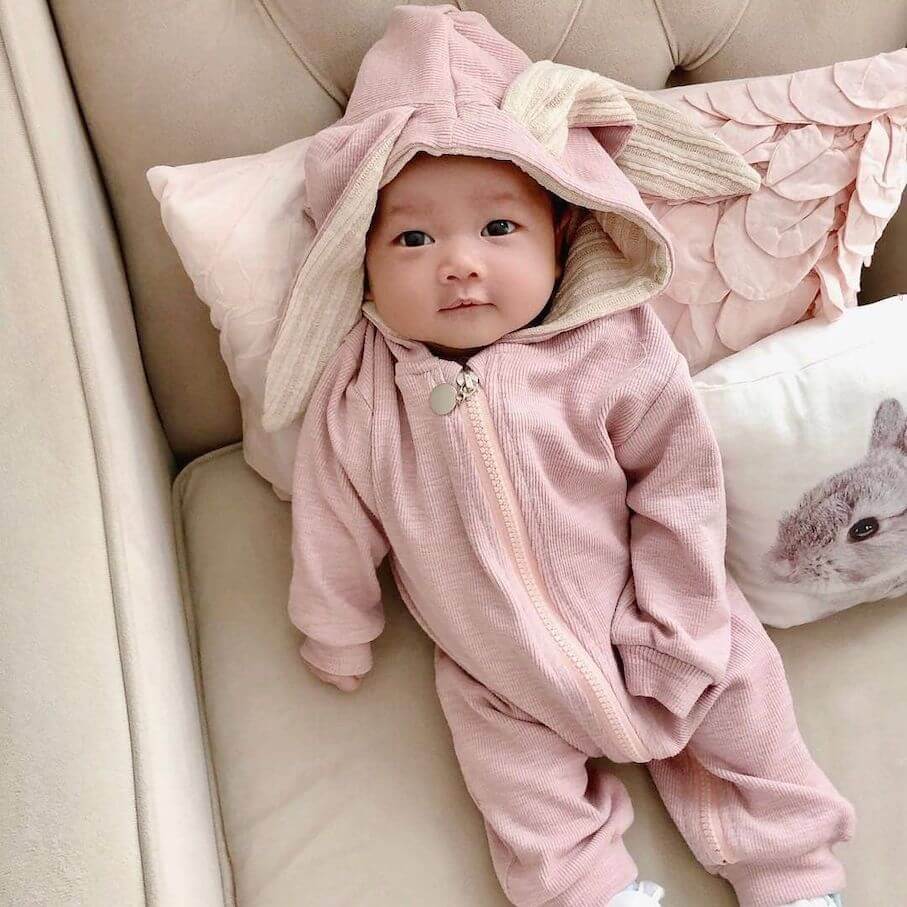 Baby wearing pink bunny onesie