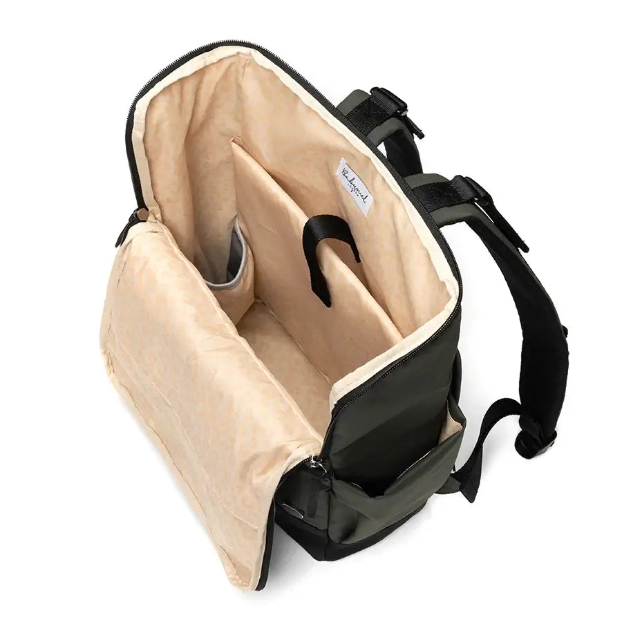 Interior view of the Finn nappy backpack in olive, featuring compartments and a soft lining for practical use.