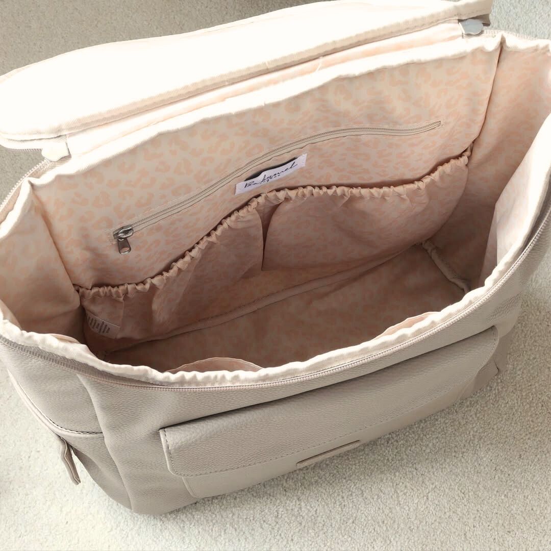 Babymel Lennox nappy backpack in oat, open showing spacious interior and pockets