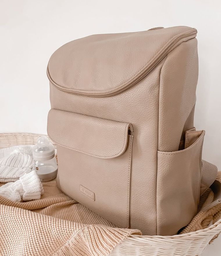 Babymel Lennox nappy backpack in oat, beautifully styled in baby nursery