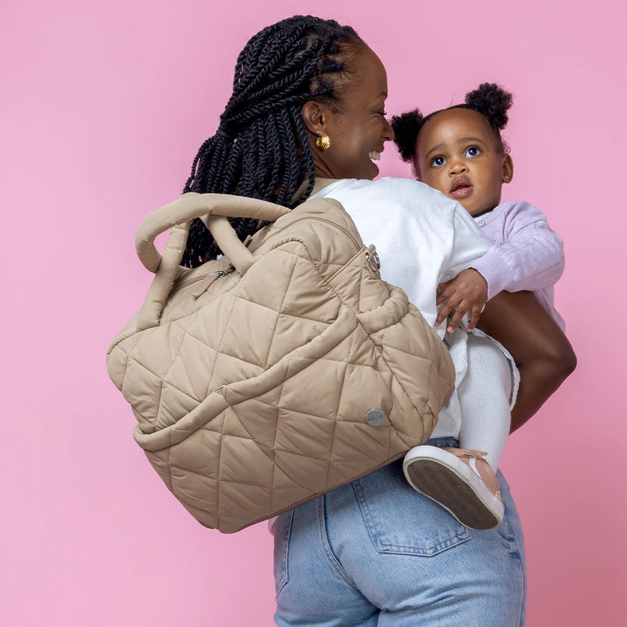 Babymel Willow Nappy Bag in Oat colour - lifestyle image with mum and baby