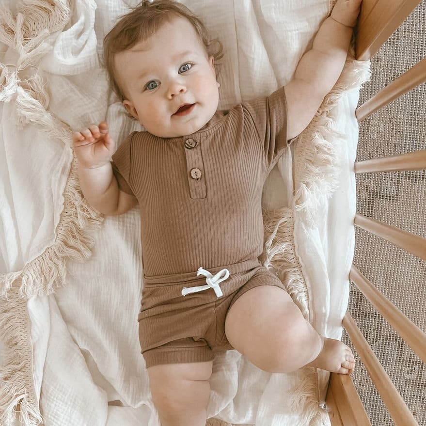 Baby wearing ribbed romper & shorts set from Lulu Babe - also comes in blue, mint green, mustard & grey