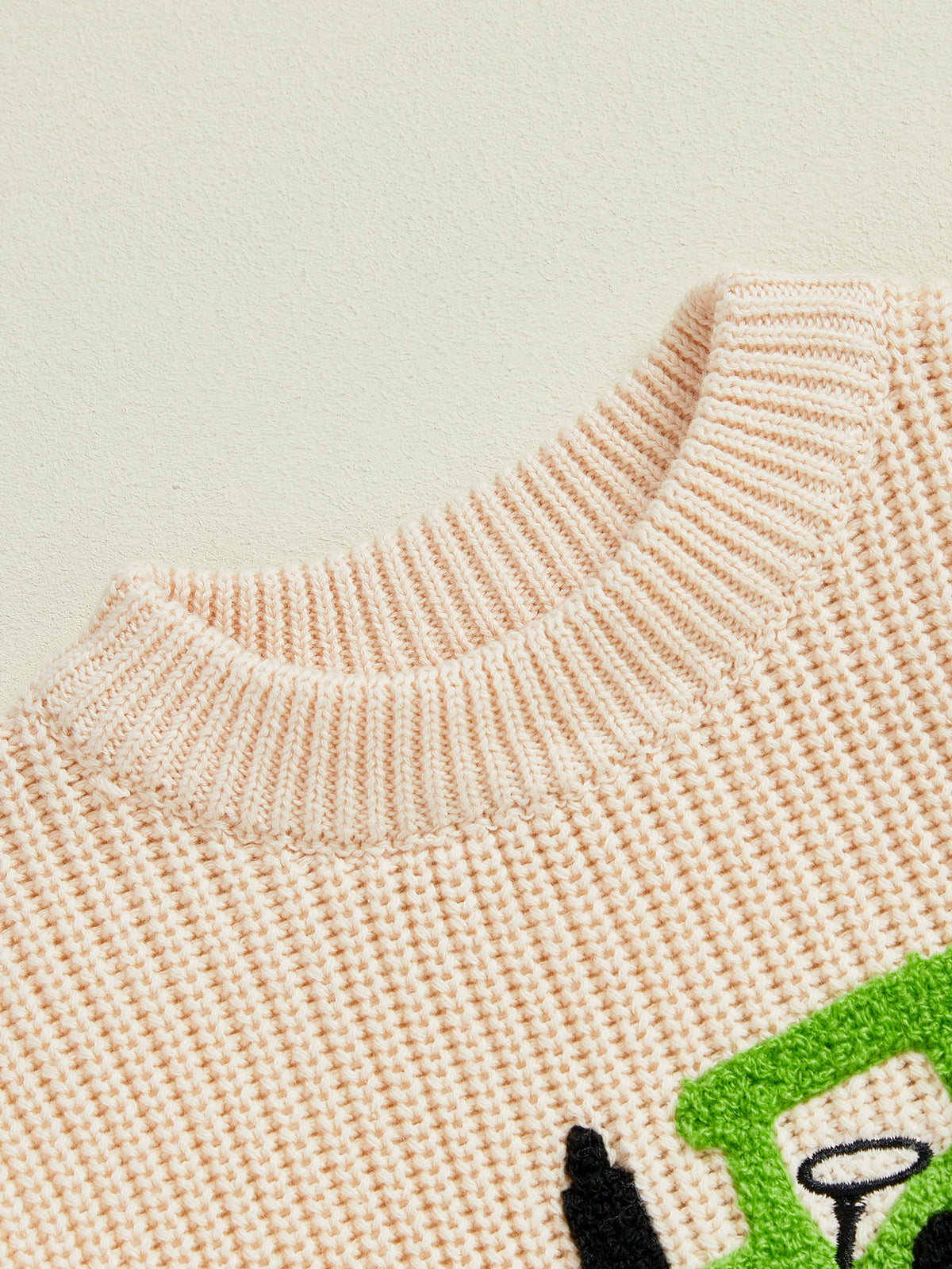Closeup of toddler tractor knit jumper