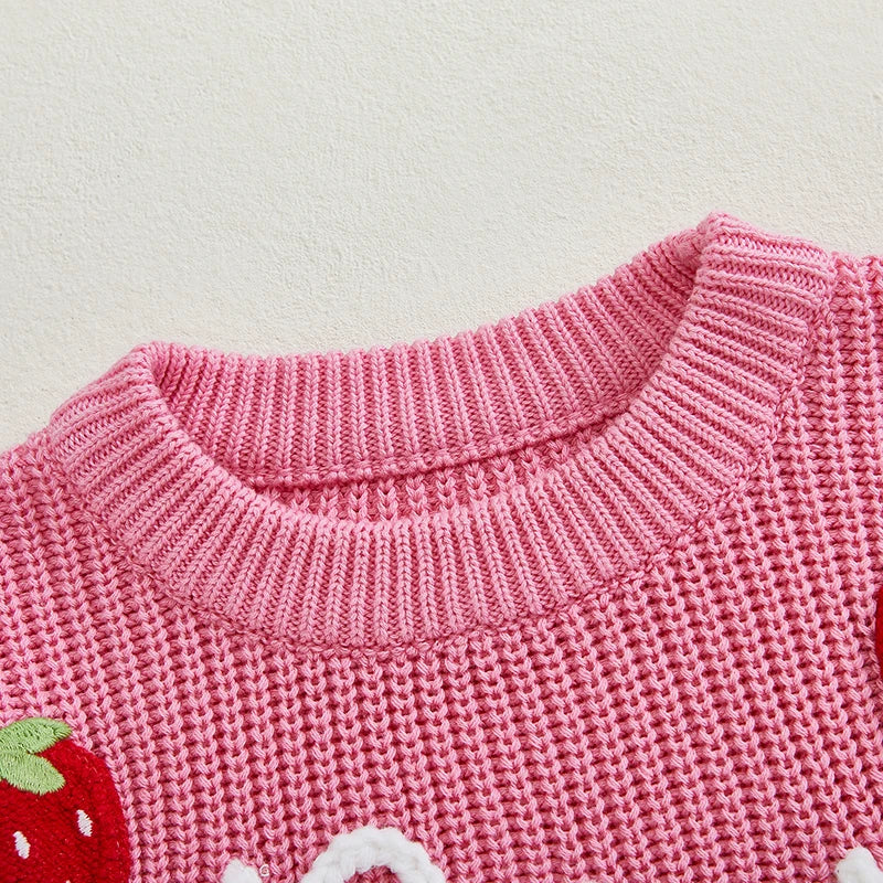 Closeup of big sister pink strawberry jumper showing chunky knit fabric