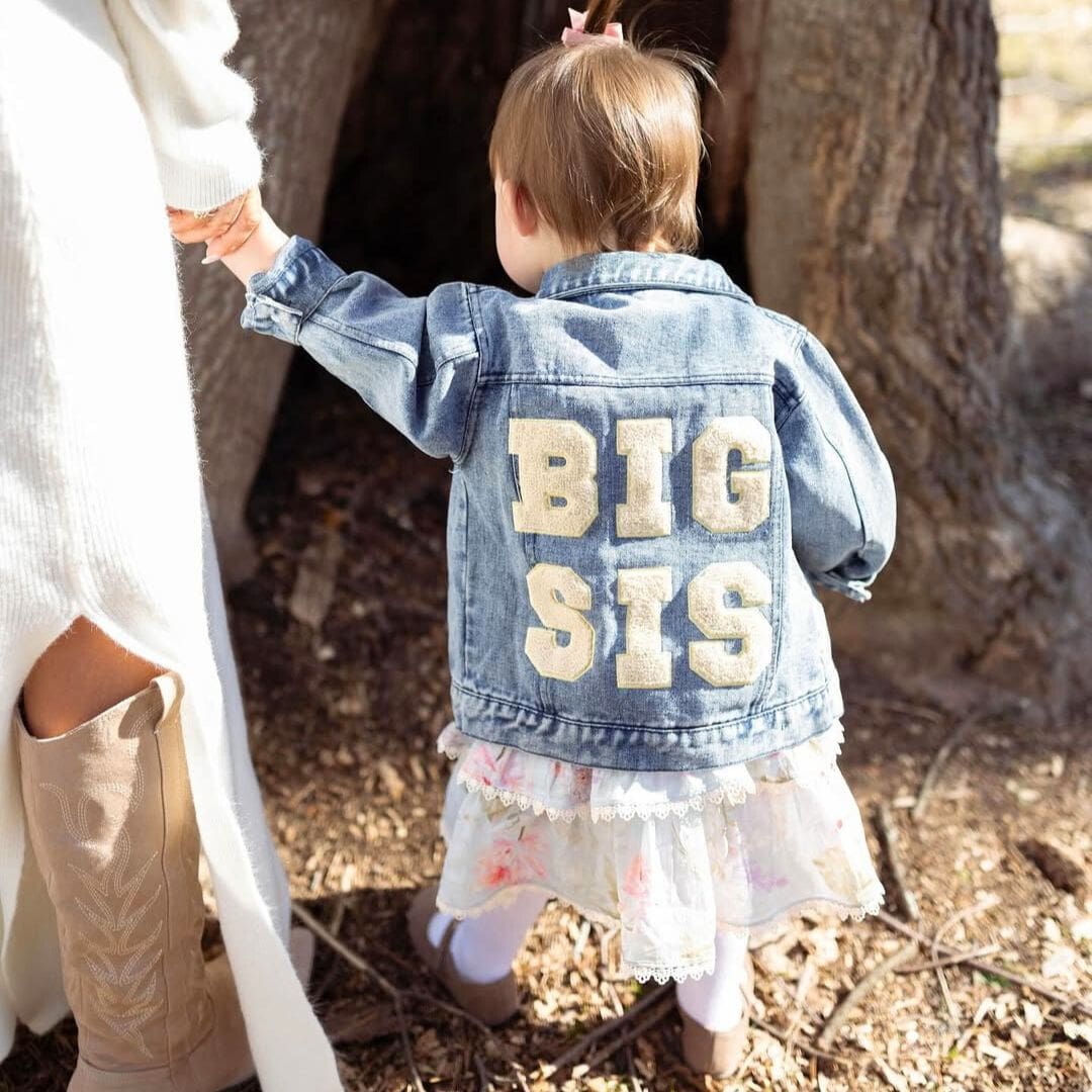 Little girl wearing Big Sis Denim Jacket from Lulu Babe