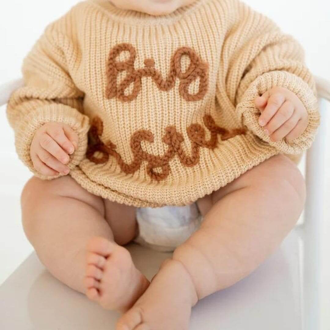 Baby girl wearing our big sister knit jumper