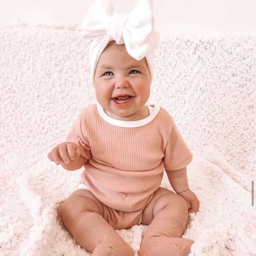 Baby girl laughing and wearing our Billie Jogger Set in pink