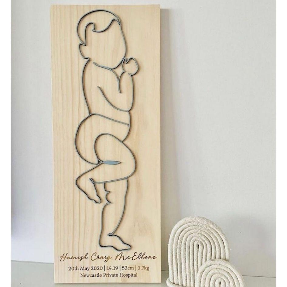 Personalised baby birth plaque with 3D baby outline on natural wood, engraved birth details.