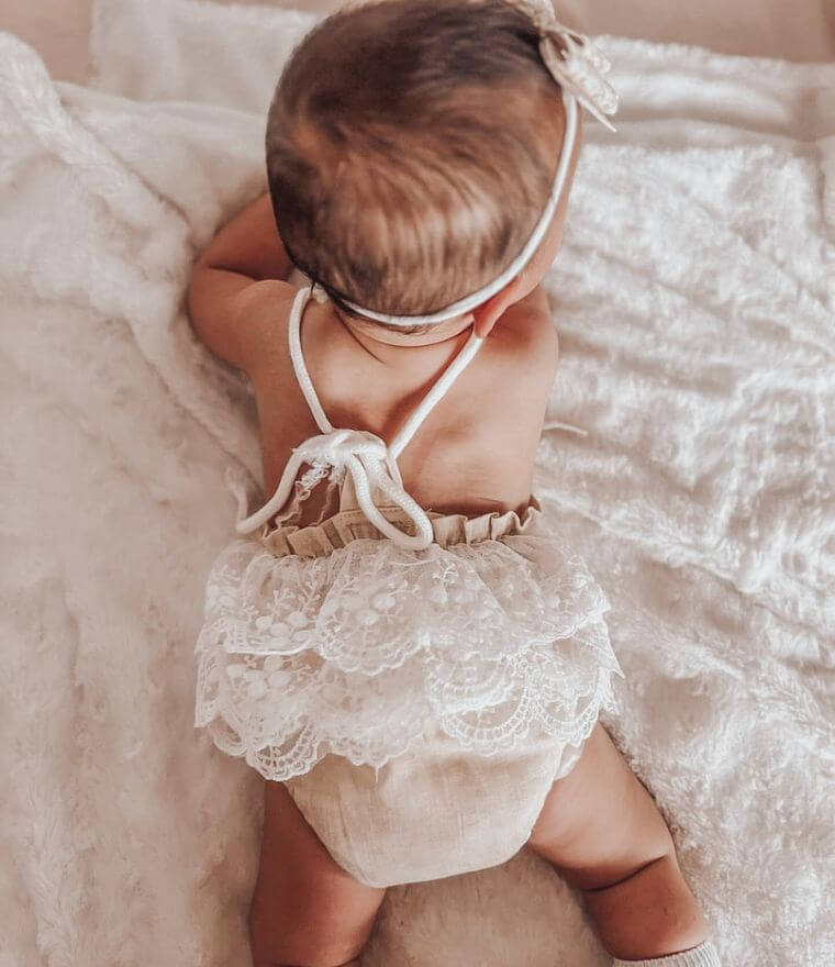 Baby girl wearing our Boho Lace romper