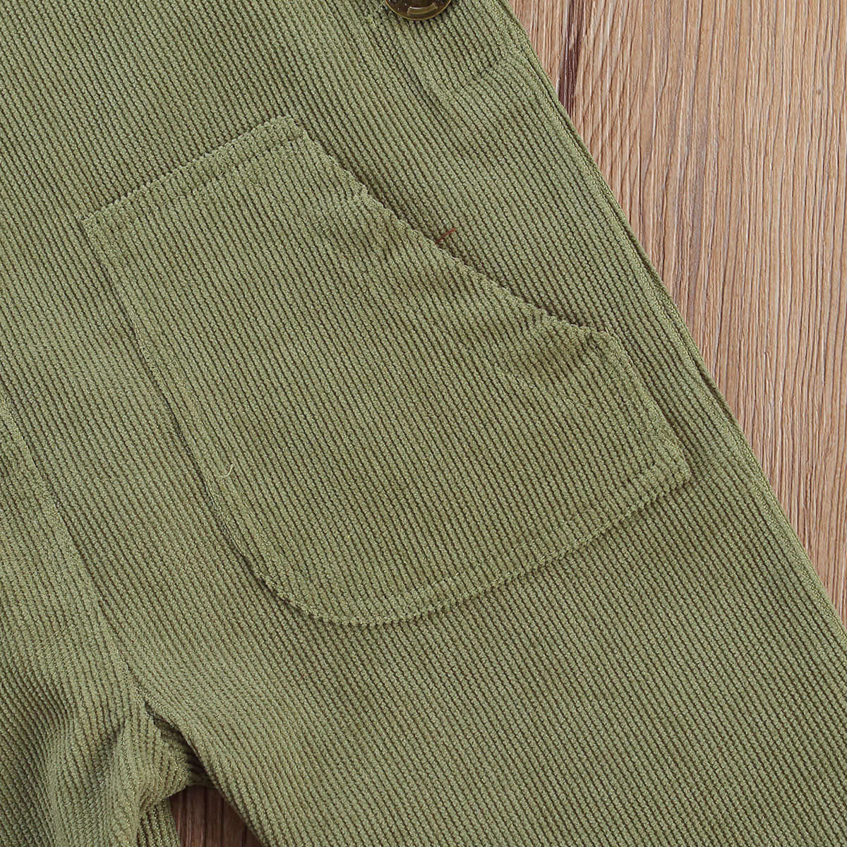 Corduroy Baby Overalls in green - closeup view of textured fabric and pocket