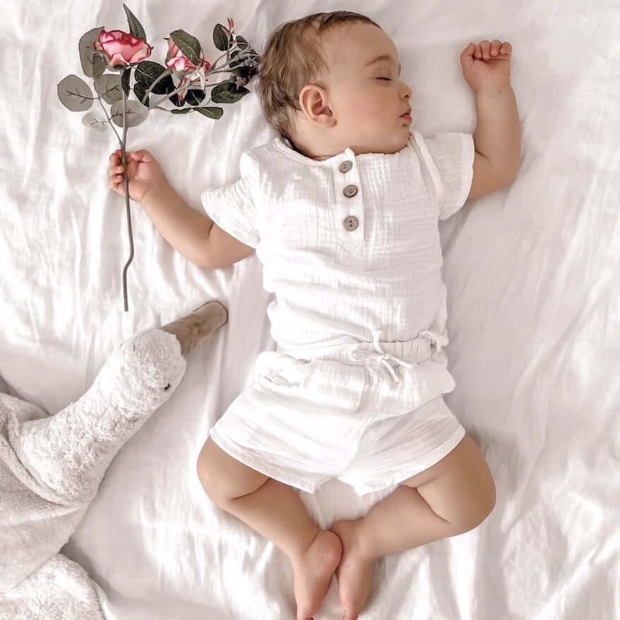 Sleeping baby boy wearing our Crushed Shorts Set in white