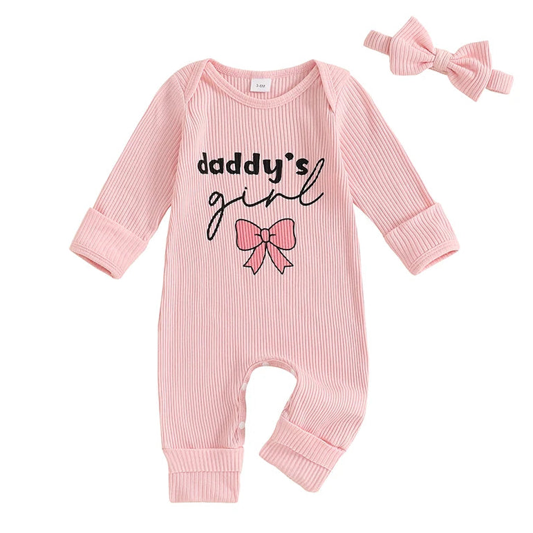 A baby's pink ribbed long-sleeve footless romper with 'daddy's girl' script, pink bow graphic and matching pink bow headband