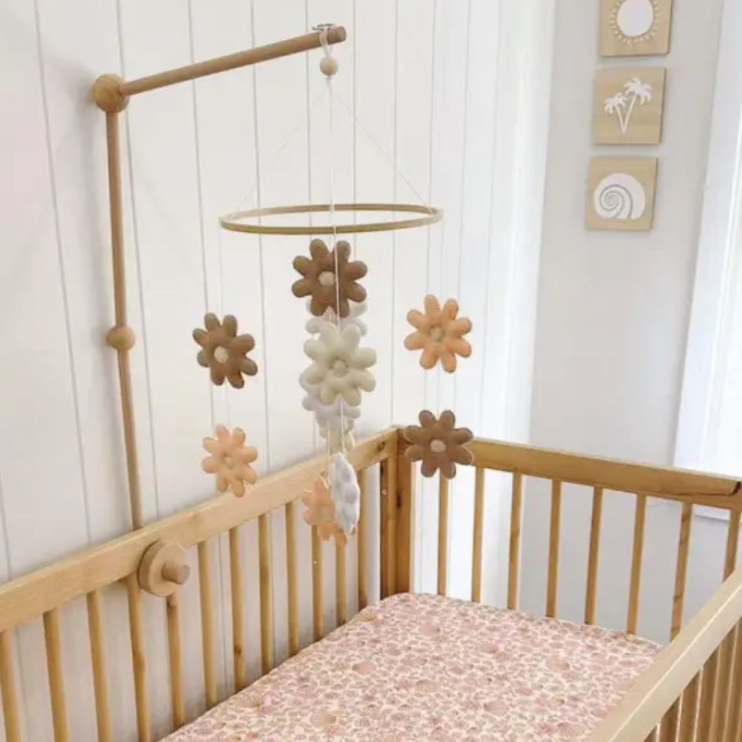 Daisy baby cot mobile featuring soft felt flowers in neutral tones, perfect nursery mobile decor for a baby's cot.