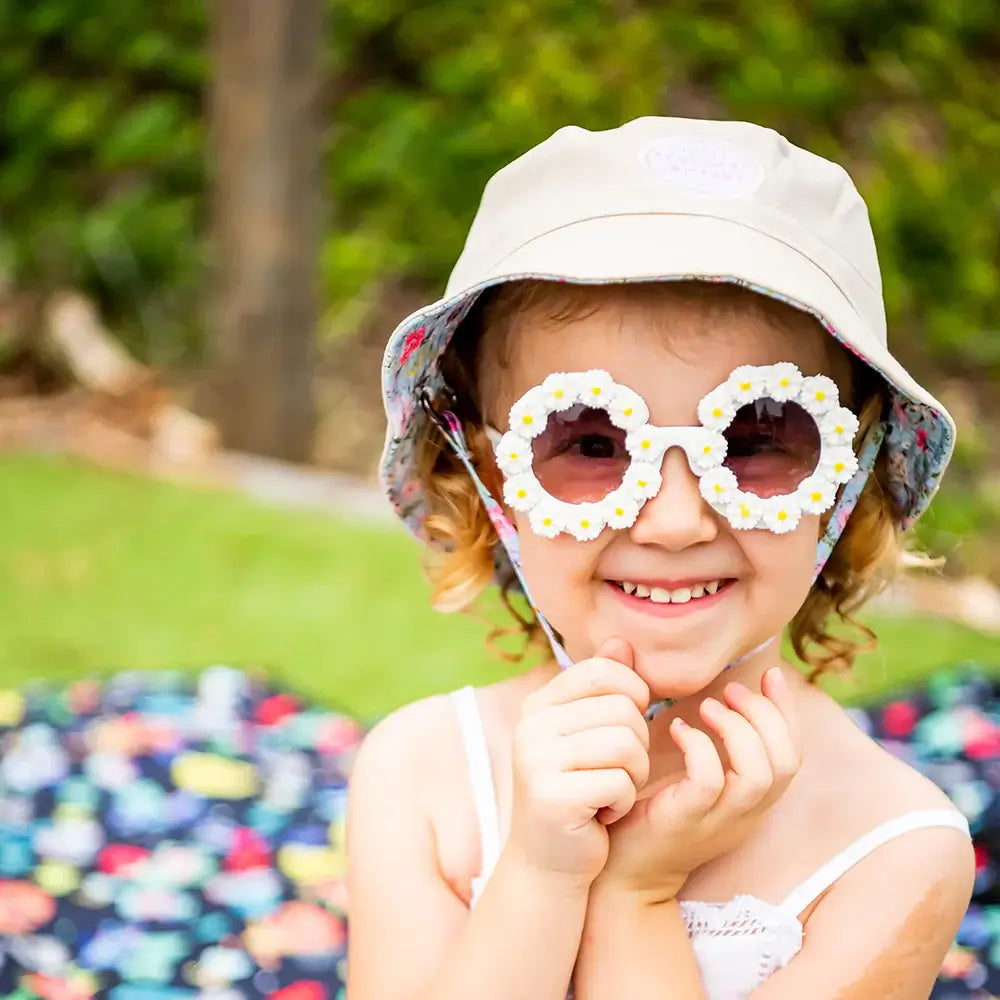 Girl wearing Daisy Toddler Sunglasses in white & yellow  | Little Renegade Company