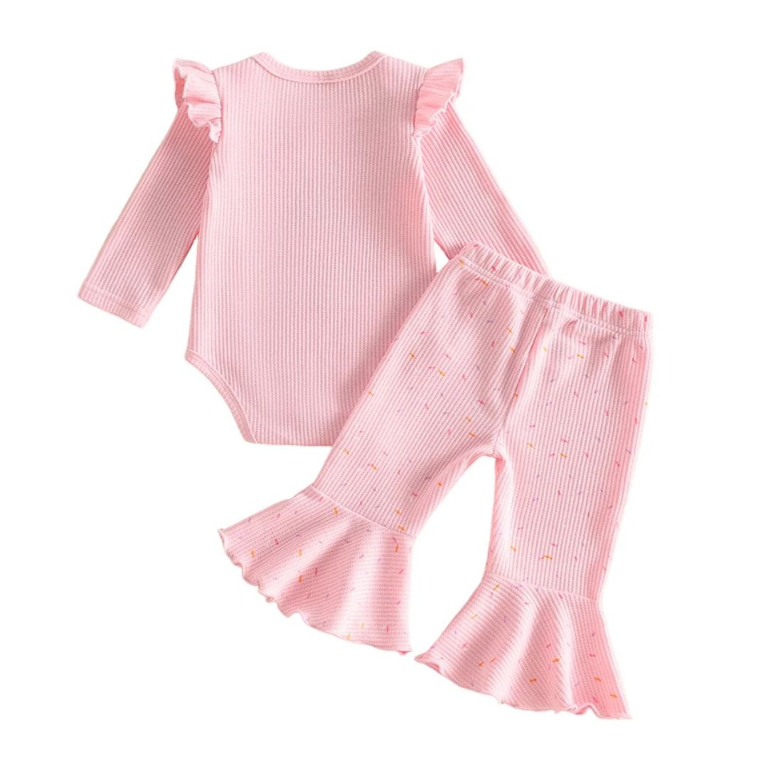 Back view of pink ribbed first birthday outfit with flare pants
