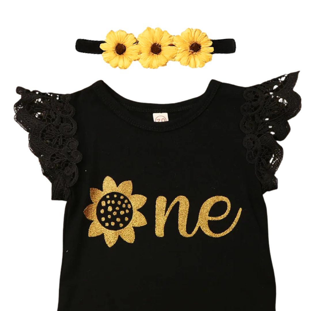 Baby girl first birthday outfit with black "One" bodysuit, yellow tutu skirt and sunflower headband