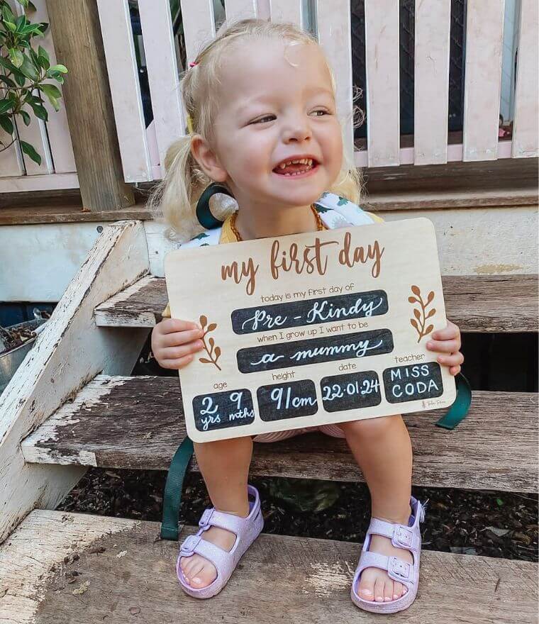 Girl holding First Day of School Wooden Board