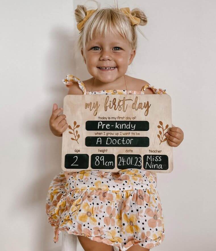 Girl holding First Day of School Wooden Board