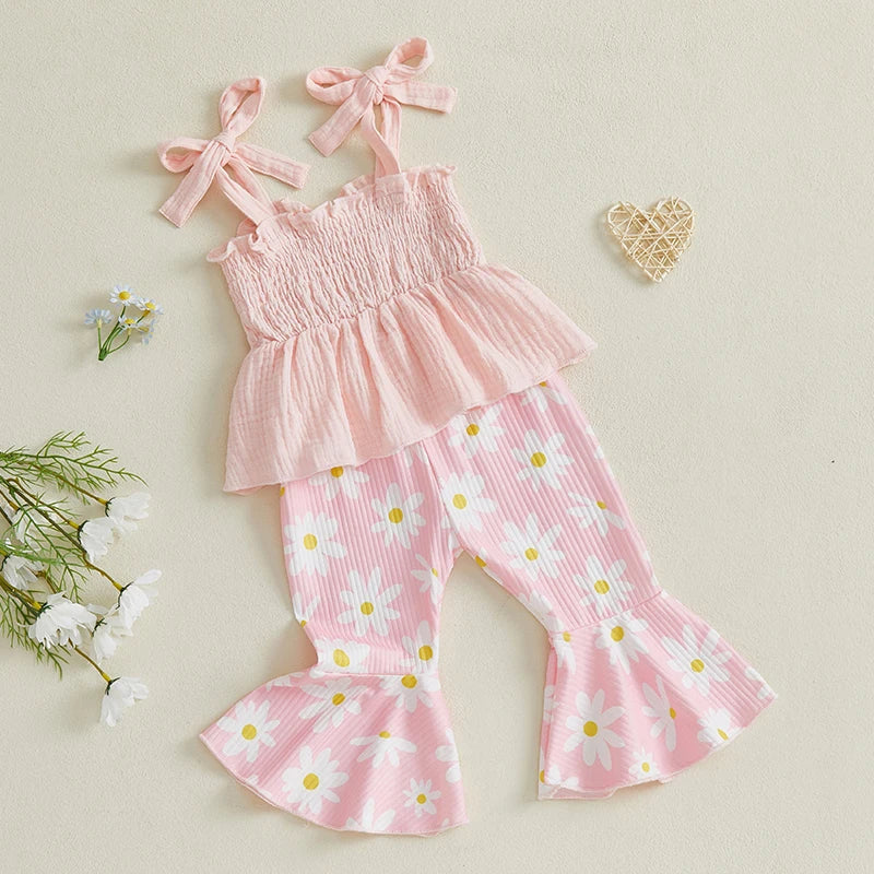 Vivian Floral Flare Set featuring a pink shirred top and daisy-print flared pants, perfect for spring and summer outings.