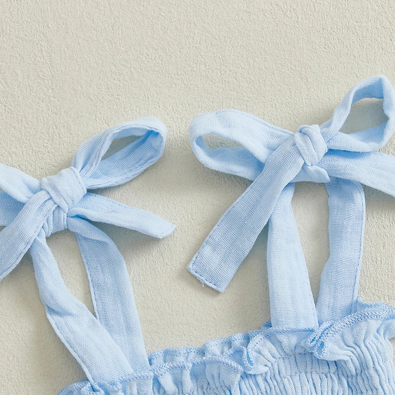 Close-up of the bow-tie straps on a shirred cotton top from the Vivian Floral Flare Set.