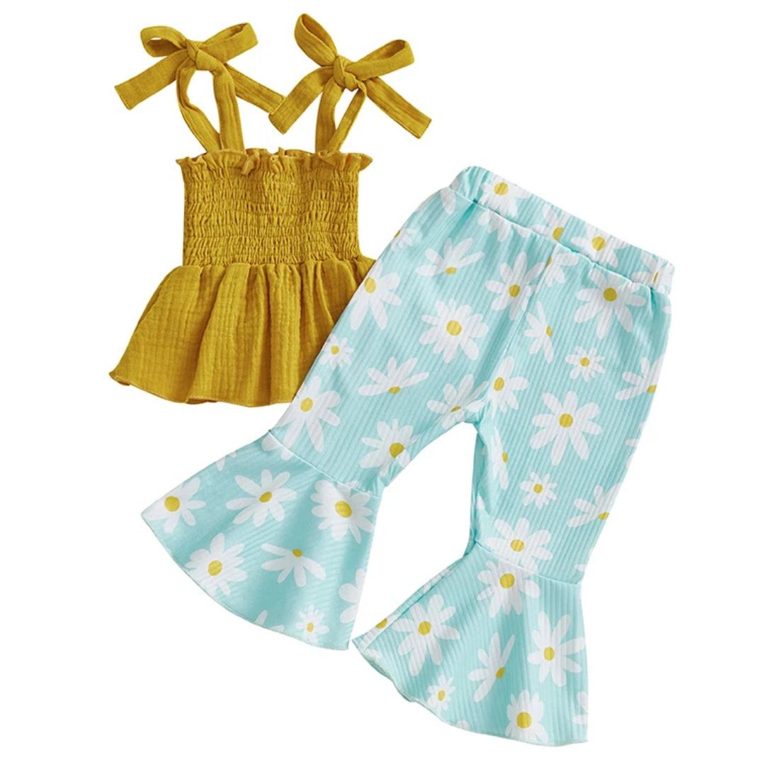Vivian Floral Flare Set featuring a yellow shirred top with bow-tie straps and teal flared pants with daisy print.