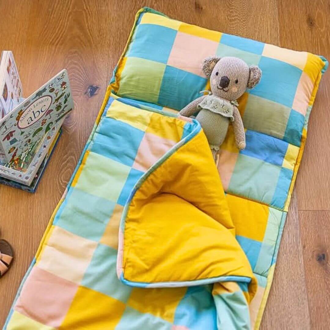 Toddler nap mat in gingham print with attached blanket and removable pillow