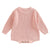 Chunky knit baby romper in soft pink with long sleeves and button detailing for winter warmth and style.