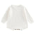 Chunky knit baby romper in white with long sleeves, perfect winter romper for comfort and style.